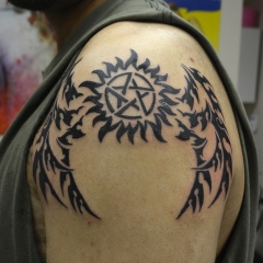 1_sun-and-tribal-dragon-wings-tattoo
