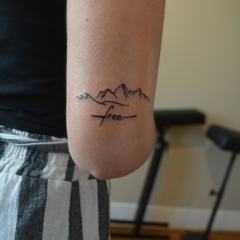 mountain-free-travel-elbow-tattoo